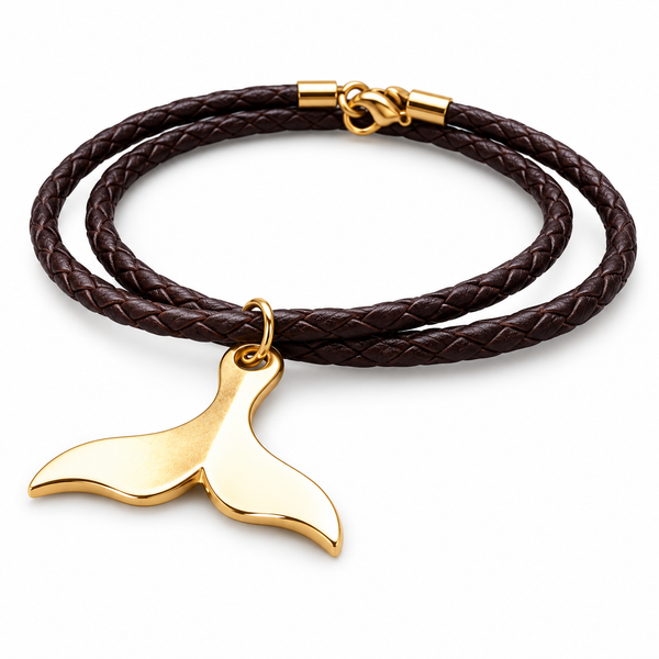 A double-strand braided dark brown leather bracelet with a polished gold-plated whale tail pendant, shown on a clean white background.