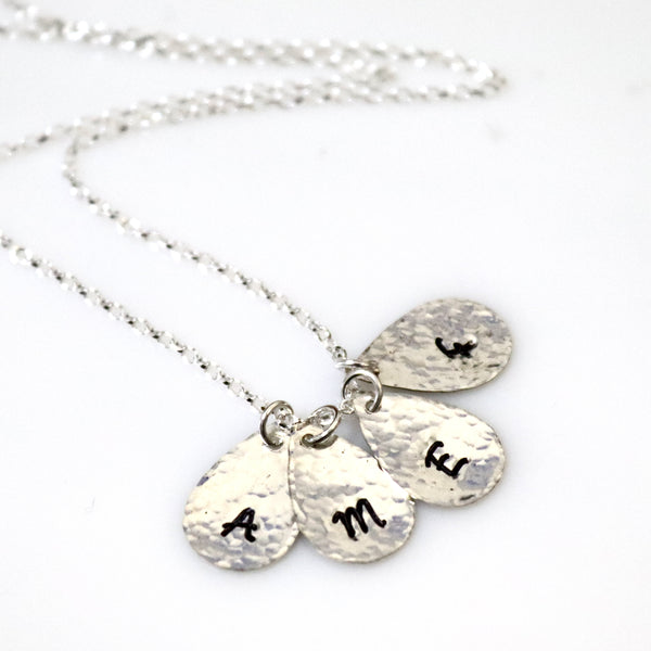 grandmother necklace with the initials  of her grandchildrens