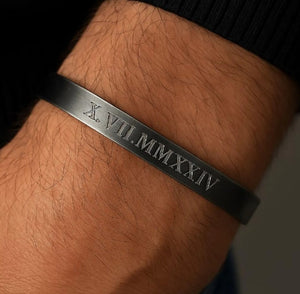 Black bracelet with Roman numeral engraving on mens wrist 