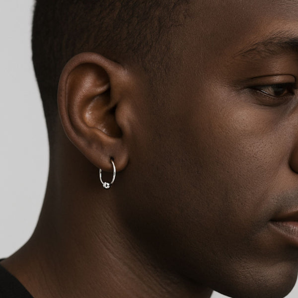 mens person wearing a silver hoop earring o 