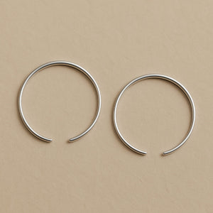 Two silver hoop earrings  