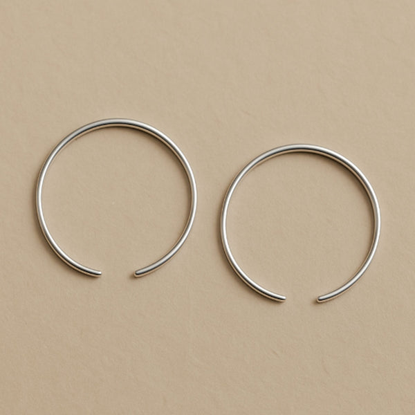Two silver hoop earrings  