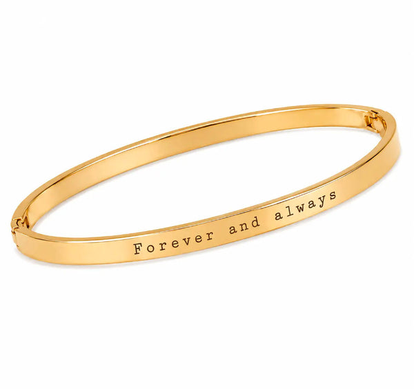 A gold bangle bracelet with the engraved text 'Forever and always' on a clean white background.