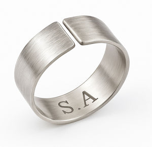 Silver letters engraved ring with engraved initials on a white background