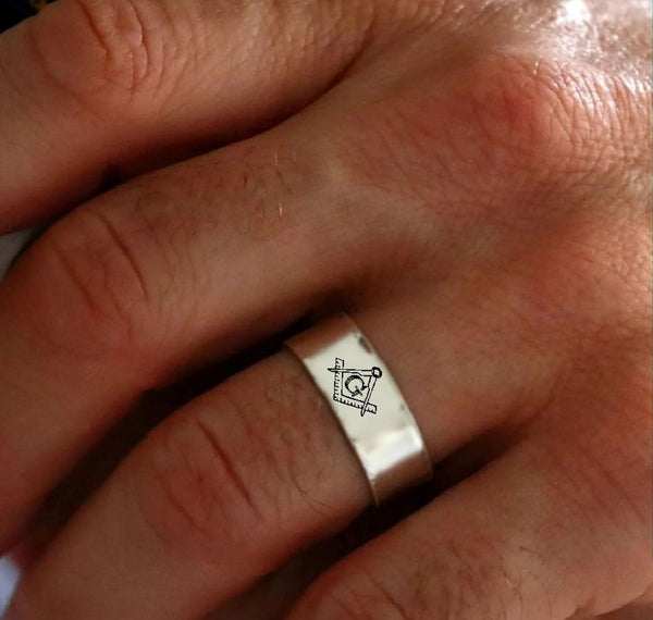 Silver ring with a symbol worn on a finger