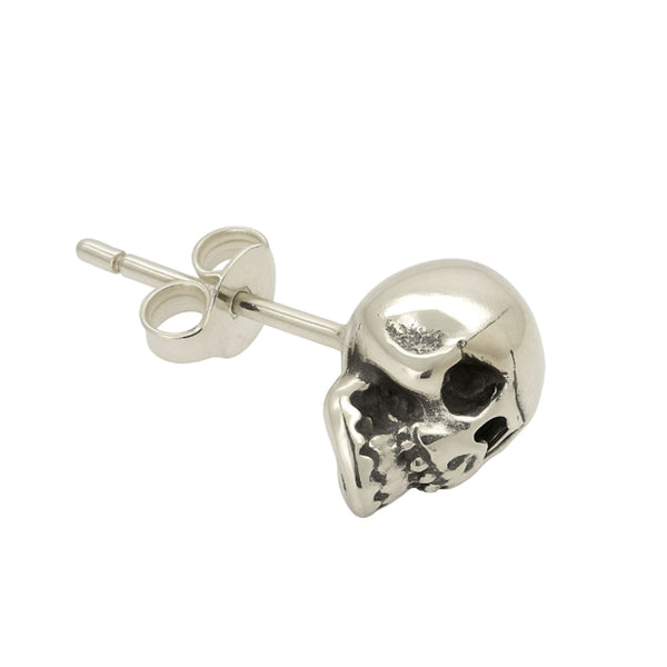 Silver skull-shaped earring on a white background